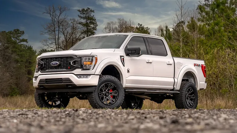 White Ford F-150 FX4 Black Widow lifted truck parked on gravel