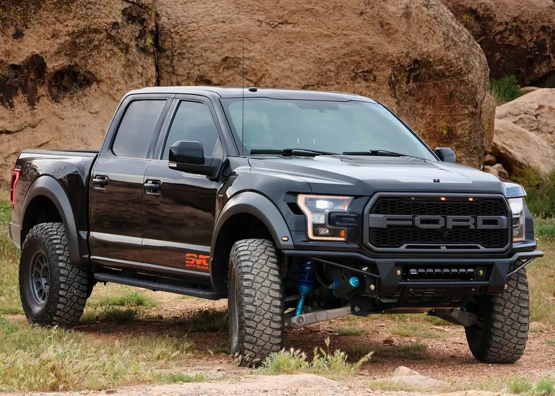 Black Ford F-150 Raptor with long-travel suspension and off-road bumper