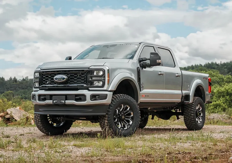 Silver Ford F-250 Super Duty Black Widow lifted truck with Power Stroke diesel