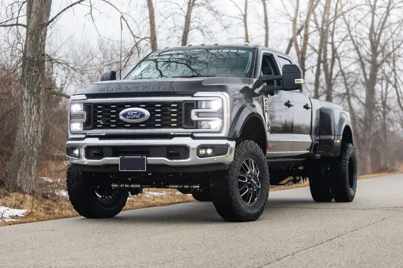 Dark gray Ford F-350 Super Duty Black Widow lifted dually truck
